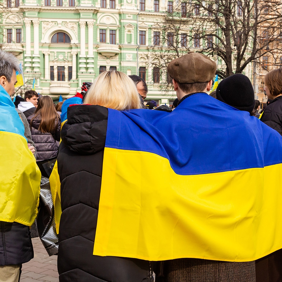 A group gathered with the Ukrainian flag to show unity.
