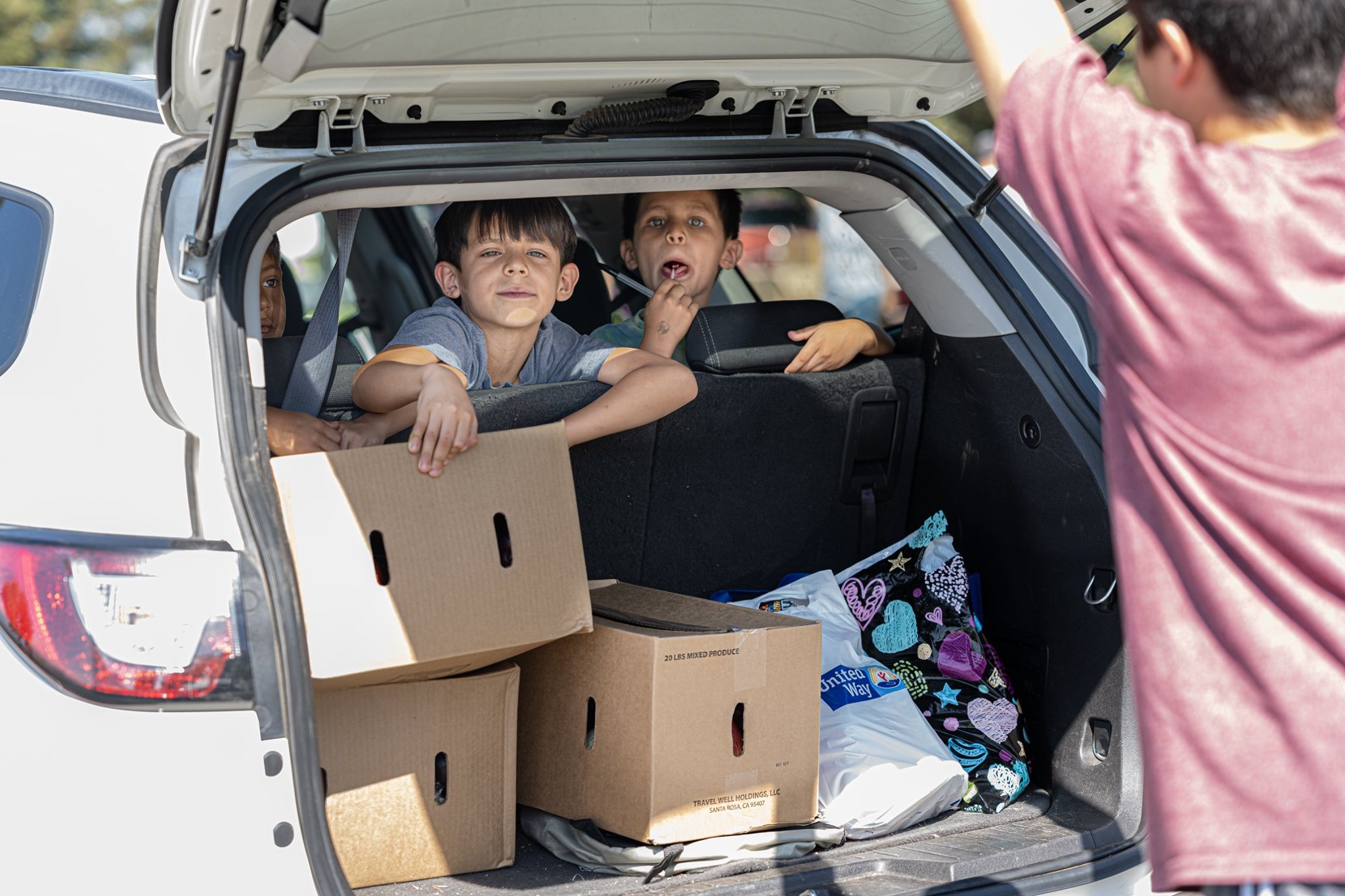 family with children receiving food boxes at Canyon Hills Assembly of God Truck to Trunk Outreach_photocred_Wayne Wong