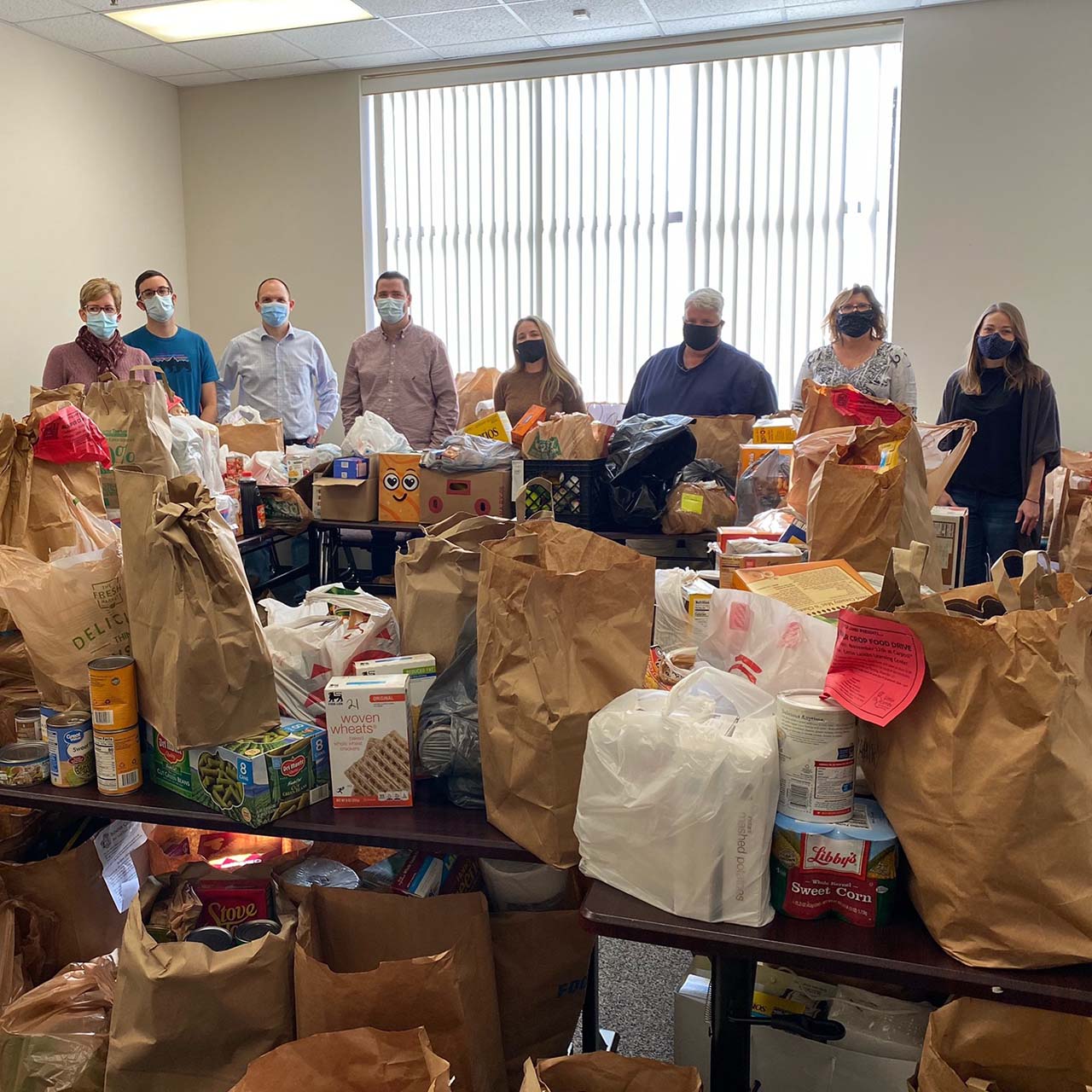20_EOY-Appeal Workers standing together in a food pantry